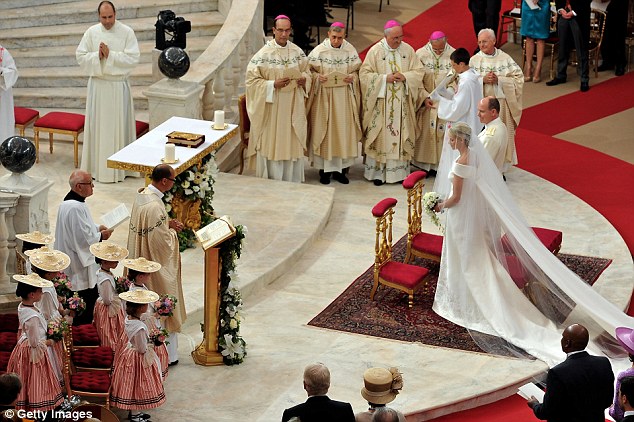 Religious ceremony: The Roman-Catholic ceremony follows the civil wedding which was held in the Throne Room of the Prince's Palace of Monaco yesterday