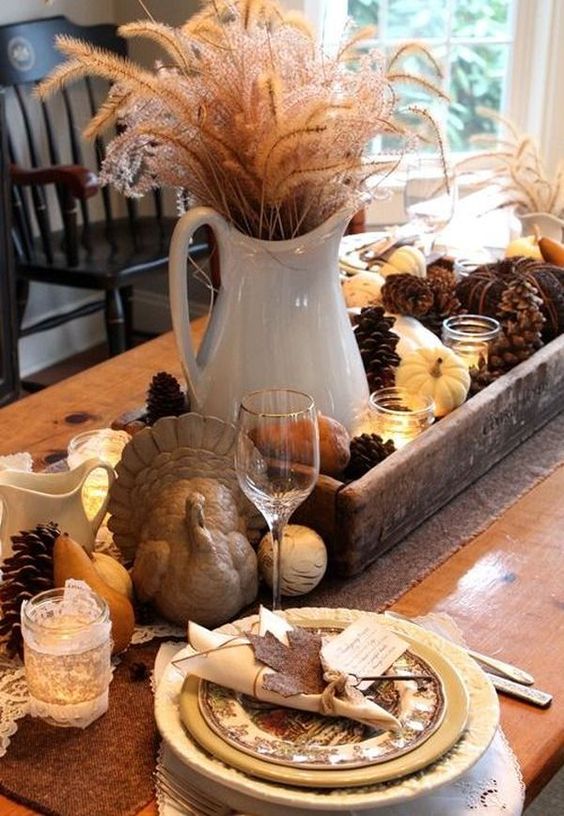 table arrangement for the center using pine cones and tiny pumpkins