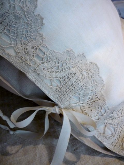 Beautiful pillow shams, edged with lace and tied with ribbon